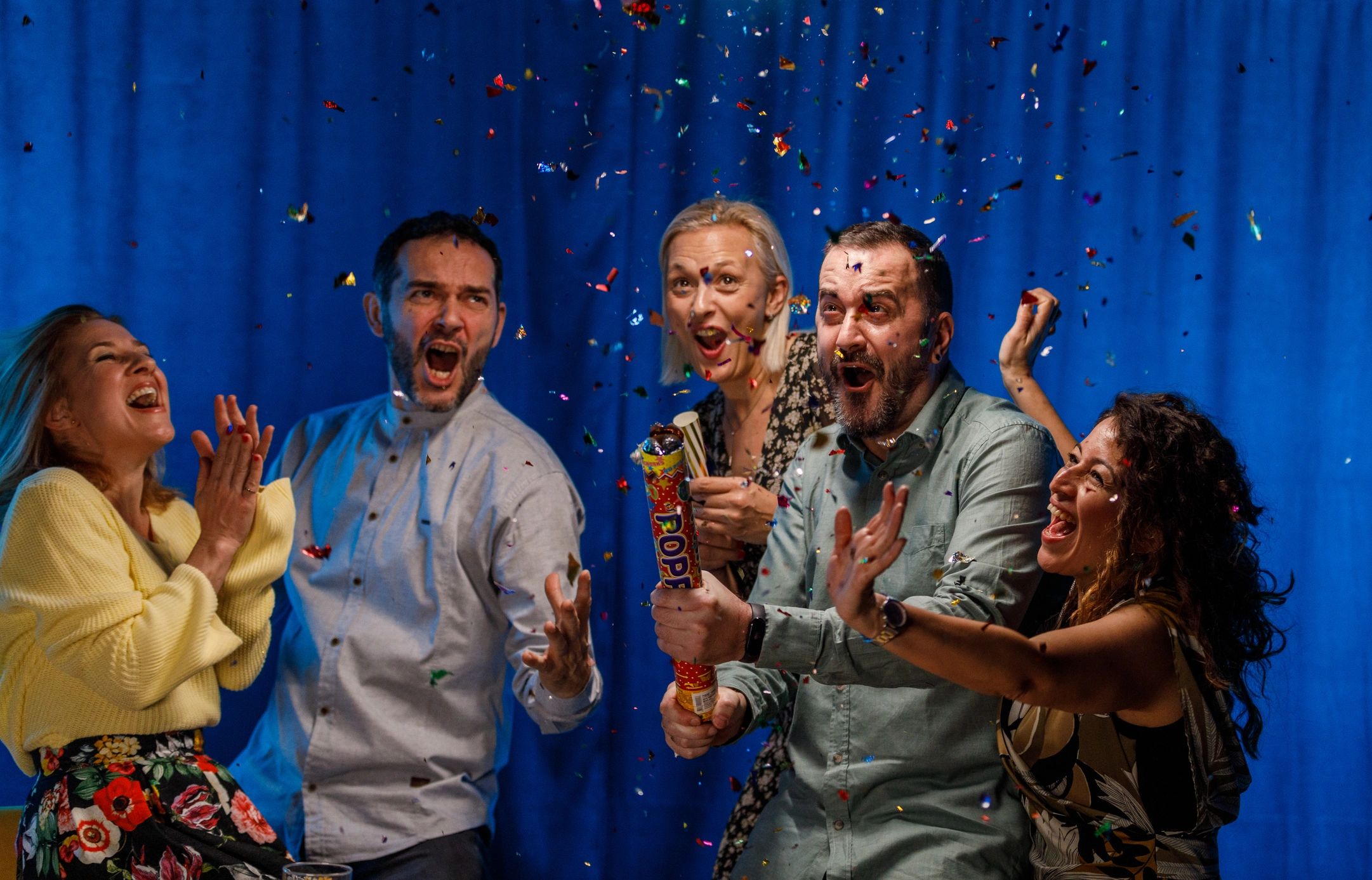 Guests celebrating and popping confetti at an event
