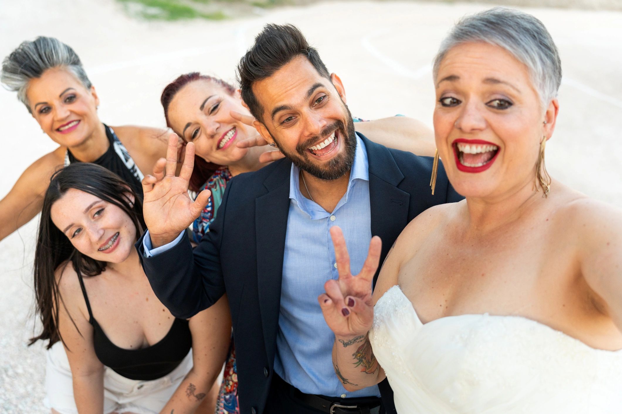 Friends celebrating and taking a fun photo at a wedding reception